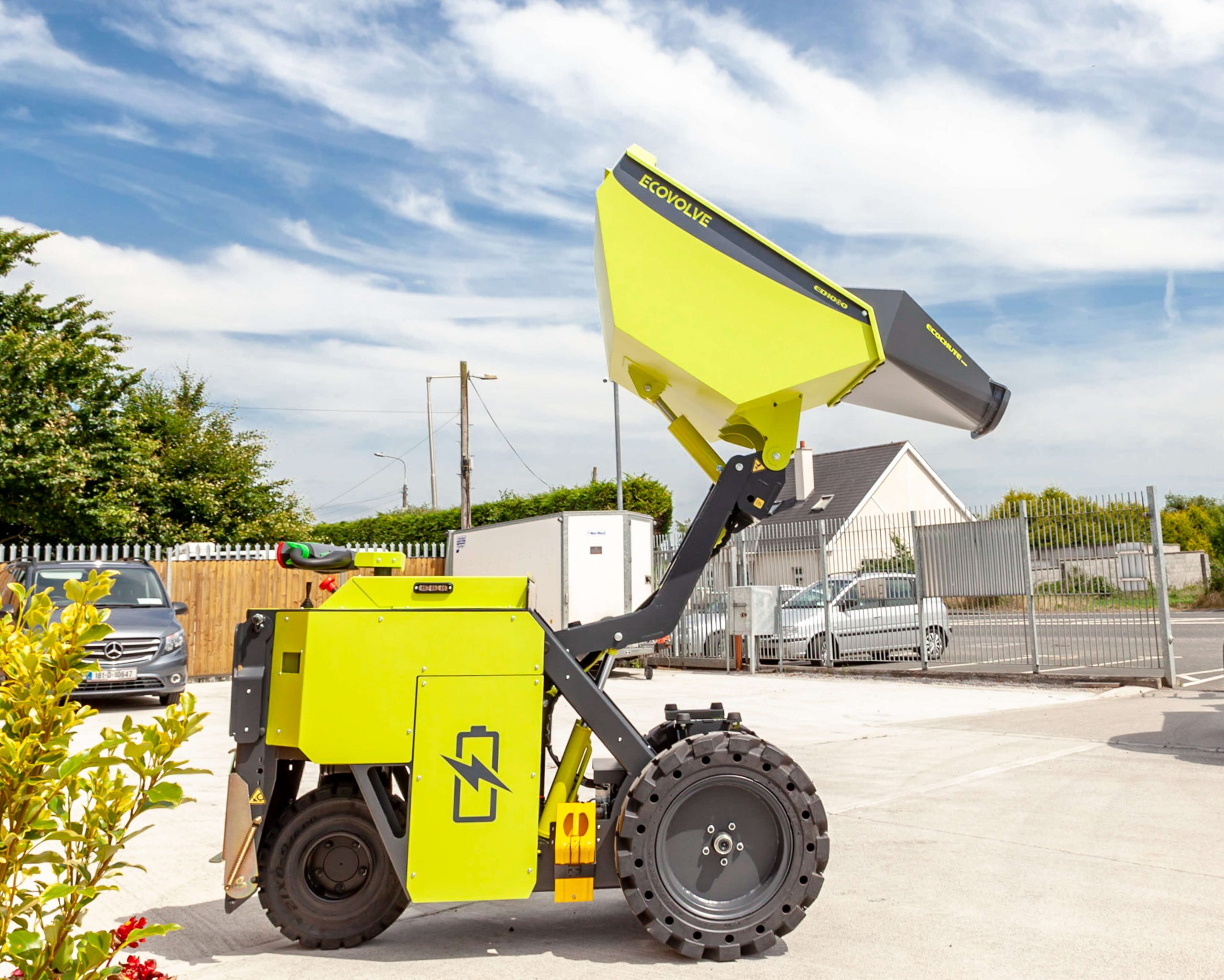 green electric dumper fully extending with concrete chute